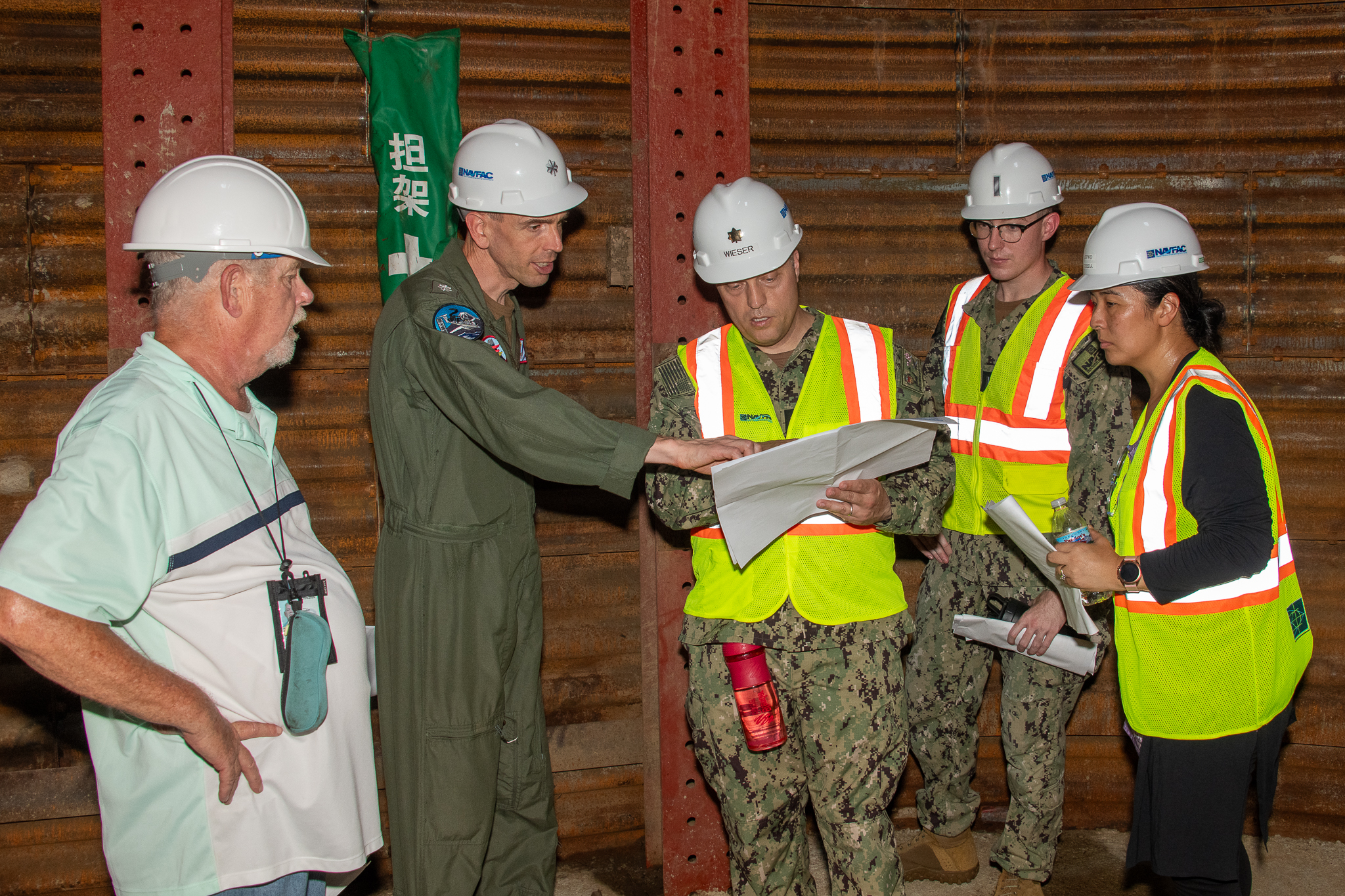 Team reviewing plans on a worksite
